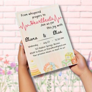 May include: A baby shower invitation with the text "From whispered prayers to Heartbeats." The invitation includes the names Eliana and Elias, the date, time, and location. Soft watercolor illustrations of baby toys are in the corners.
