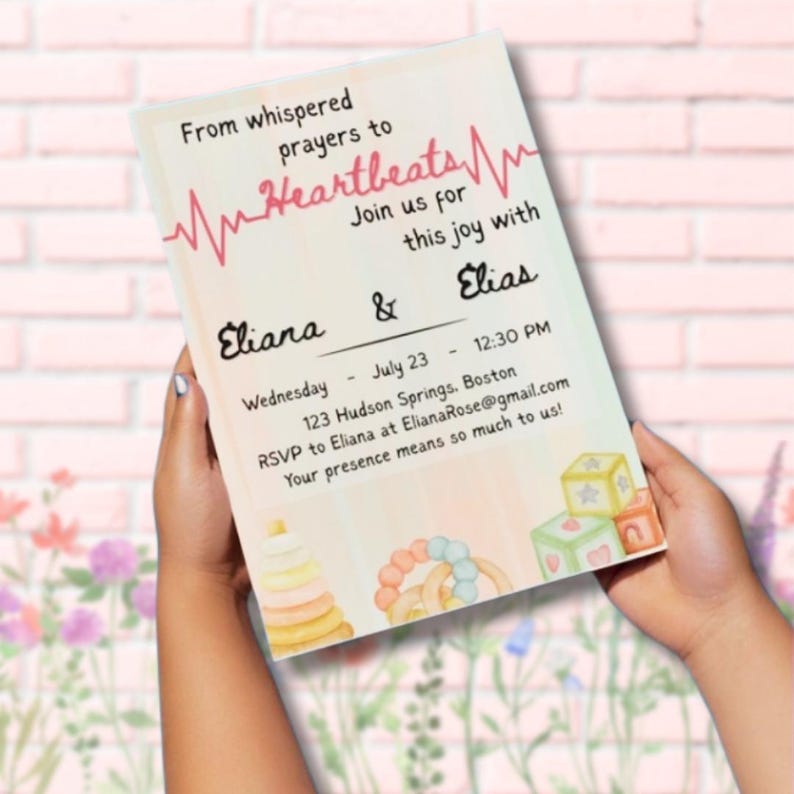 May include: A baby shower invitation with the text "From whispered prayers to Heartbeats." The invitation includes the names Eliana and Elias, the date, time, and location. Soft watercolor illustrations of baby toys are in the corners.