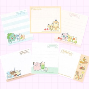 May include: Six different Pokemon themed memo pads with lined paper. Each pad features a different Pokemon character and the word "Pokemon" at the top. The pads are all white with a light blue, pink, or green border.