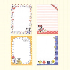 May include: Four colorful memo pads featuring Disney characters. One pad has a Minnie Mouse theme, another has a striped pattern with a bow, a third has Daisy Duck and Pluto, and the last has Mickey Mouse and friends. Each pad has a different border design.