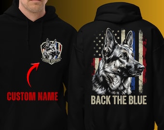 May include: Black hoodie featuring a German Shepherd graphic and the text "BACK THE BLUE" on the back. The front displays a shield with a dog graphic and the text "FRANK SERPICO". The words "CUSTOM NAME" are also visible.