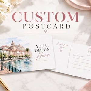 May include: Two rectangular postcards with white backgrounds. The left card features a watercolor illustration of a European waterfront with buildings, a lamppost, and boats. The right card shows a template with lines for address and stamp.