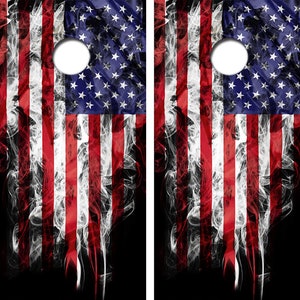 May include: Two wooden cornhole boards with a red, white, and blue American flag design. The flag is faded and has a smoky effect.