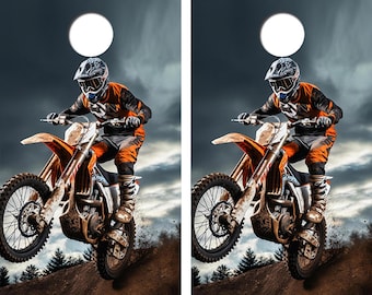 May include: A dirt bike jumps in the air with a rider wearing a helmet and orange and black gear. The background is a cloudy sky with a white circle.