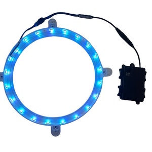 May include: A blue LED light ring with a battery pack. The ring is made of clear plastic and has four mounting points. The battery pack is black and has a label that says "3.0V 2.0Ah".