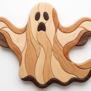 May include: A ghost-shaped wall decoration crafted from multiple pieces of wood in varying natural tones, including light beige, medium brown, and dark espresso. The design features smooth, flowing curves and dark oval eyes and mouth.