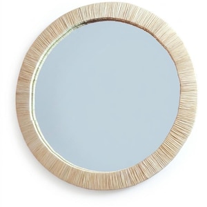 May include: A circular wall mirror featuring a wide frame constructed from tightly arranged, light beige natural fibers. The reflective glass surface is smooth and clear, centered within the textured, straw-like border that radiates outward.