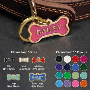 May include: A dark brown leather collar with a gold-toned metal bone-shaped pet tag featuring the name BAILEY in pink enamel. The image displays five size options ranging from 14 x 30mm to 23 x 43mm and a color chart showing 16 different shades.