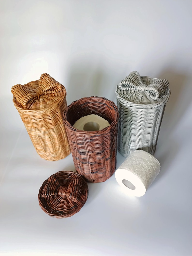 Three woven toilet roll holders in neutral tones; brown basket shown with toilet paper inside for scale. Ideal rustic bathroom decor