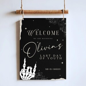 May include: Black and white welcome sign with a skeleton hand making a rock and roll gesture. The sign reads "Welcome, we are mourning Olivia's Last Day of Youth, XIII - IX - MMXXV".