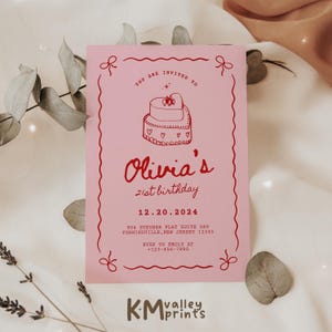 May include: Pink invitation card with a red border and a red illustration of a heart-shaped cake with the text "You are invited to Olivia's 21st birthday 12.20.2024 904 Steuber Flat Suite 089 Yoshikoville, New Jersey 12345 RSVP to Emily at +123-456-7890" and the logo "KMvalley prints" at the bottom.