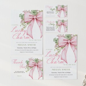 May include: A set of baby shower invitations and cards with a pink bow and shamrock design. The text includes "A Little Lucky Charm Is On The Way!" and "Thank You". The invitations include the name Megan Smith and event details.