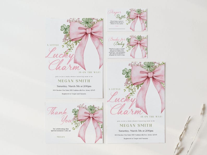 May include: A set of baby shower invitations and cards with a pink bow and shamrock design. The text includes "A Little Lucky Charm Is On The Way!" and "Thank You". The invitations include the name Megan Smith and event details.