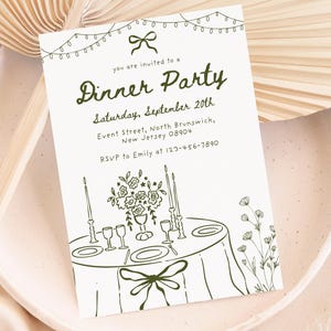 May include: A white invitation card with a green illustration for a dinner party. The card features the text "Dinner Party" and event details. The illustration includes a table setting with flowers, candles, and a bow.