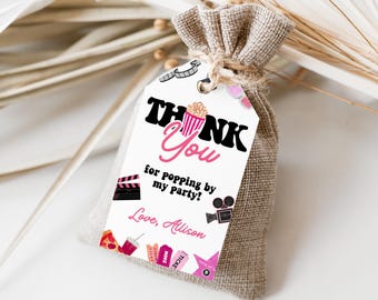 May include: White thank you tag with pink and black text that says "Thank You for popping by my party! Love, Allison". The tag has a pink and white popcorn bucket, a black and white film reel, a black and white movie clapper, a pink and white movie ticket, a pink star, and a pink and white soda cup.