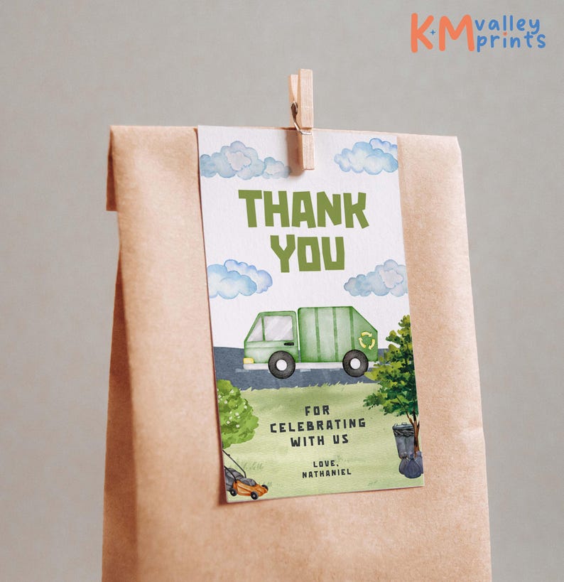 May include: A gift tag with a watercolor illustration of a green garbage truck, clouds, and grass. The tag reads "THANK YOU" and "FOR CELEBRATING WITH US". Includes the name "NATHANIEL". Attached to a brown paper bag with a wooden clip.