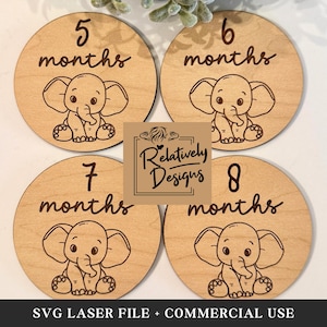 May include: Four wooden circles with a light brown wood grain. Each circle has a white elephant with a black outline and a black trunk. The circles are labeled with the numbers 5, 6, 7, and 8 and the word "months". The text "SVG LASER FILE + COMMERCIAL USE" is at the bottom of the image.