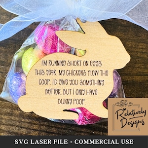 May include: A wooden bunny cutout with the text "I'm running short on eggs this year. My chickens flew the coop. I'd give you something better, but I only have bunny poop." The bunny is holding a bag of colorful Easter eggs.