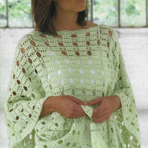 May include: A light green crochet poncho with openwork detailing. The poncho features a loose, flowing design with wide sleeves and a tassel accent. The open weave creates a delicate, airy look, perfect for layering.