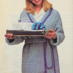 May include: A light blue crocheted robe with a purple trim and a matching sash. The robe is worn by a woman holding a silver tray with wrapped gifts.