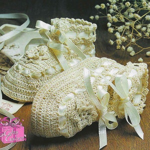 May include: A pair of crocheted baby booties with white satin ribbon accents. The booties are made with a delicate stitch pattern and feature a flower design on the toe.