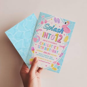 Puede incluir: Una invitación de cumpleaños azul claro con un sobre a juego. La invitación presenta el texto "Splash INTO 12" con ilustraciones coloridas de un flamenco, helado y una pelota de playa. La invitación también incluye detalles de la fiesta.