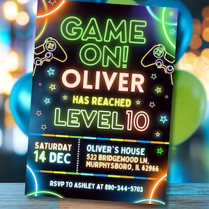 May include: A black invitation with neon green and orange accents. The text reads "GAME ON! OLIVER HAS REACHED LEVEL 10." Includes date, address, and RSVP information. Features controller graphics and star decorations.