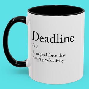 May include: White ceramic mug with a black handle and interior. The mug features the word "Deadline" in a bold, black font, along with a definition: "A magical force that creates productivity."