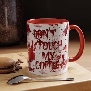 May include: White ceramic coffee mug with a red rim and handle. The mug has a red splatter pattern and the text "Don't Touch My Coffee" in red.
