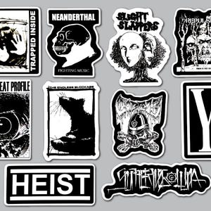 May include: A collection of ten black and white stickers featuring various graphic designs, including text such as Lack of Interest, Neanderthal, Slight Slappers, Repulsion, Low Threat Profile, The Endless Blockage, Heist, and stylized band logos.