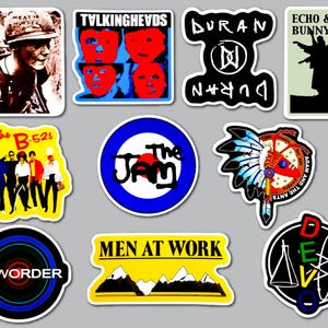 May include: A collection of ten music-themed stickers featuring band names and graphics including The Smiths, Talking Heads, Duran Duran, Echo & The Bunnymen, The B-52s, The Jam, Adam and the Ants, New Order, Men at Work, and Devo with various colors.