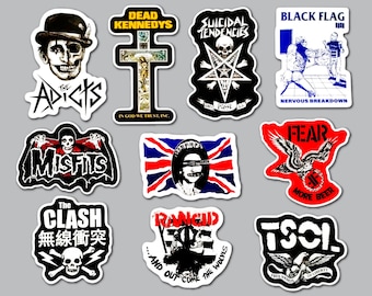 May include: A collection of ten punk rock band stickers featuring various graphic designs, including The Adicts, Dead Kennedys, Suicidal Tendencies, Black Flag, Misfits, a Sex Pistols style flag, Fear, The Clash, Rancid, and TSOL logos and imagery.