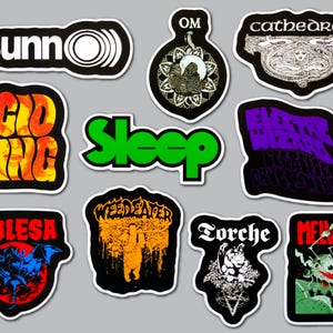 May include: A collection of ten die-cut vinyl stickers featuring various band logos and graphic illustrations. The designs include text such as Sunn O))), Om, Cathedral, Acid King, Sleep, Electric Wizard, Kylesa, Weedeater, Torche, and Melvins.