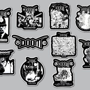 May include: A collection of eleven black and white stickers featuring the band name DOOM. The designs include various graphic illustrations, skulls, figures, and text such as Police Bastard, Lost The Fight, Total Doom, Relief, and Consumed To Death.