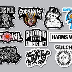 Pode incluir: Uma coleção de dez adesivos de vinil cortados com vários logotipos de bandas e designs gráficos, incluindo textos como Jesus Piece, God's Hate, Drain, Scowl, Gridiron, Harms Way, Outta Pocket, Spy e Gulch, com ilustrações em preto, branco e colorido.