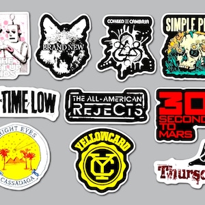 May include: A collection of ten music-themed vinyl stickers featuring band logos and artwork including The Get Up Kids, Brand New, Coheed and Cambria, Simple Plan, All Time Low, The All-American Rejects, 30 Seconds to Mars, Bright Eyes, Yellowcard, and Thursday.
