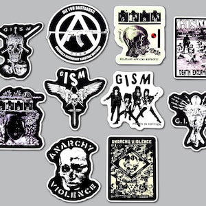 May include: A collection of ten black and white stickers featuring the band GISM. Designs include skulls, an anarchy symbol with a rifle, band members, and text such as DIE YOU BASTARDS, MILITARY AFFAIRS NEUROTIC, DEATH EXCLAMATIONS, and ANARCHY VIOLENCE.
