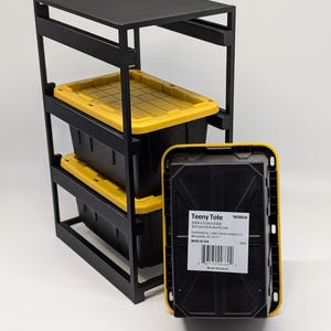 May include: A black metal storage rack with three black and yellow Teeny Totes. The totes are 4.8 x 3.3 x 2.4 inches. The rack has a top shelf and two lower shelves for storage. The totes are made in the USA.