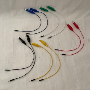 May include: Assortment of electrical test leads with alligator clips and probe tips. The leads are black, red, yellow, green, blue, and white.