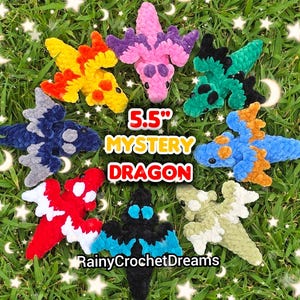 May include: Eight 5.5 inch crochet dragon plushies in various colors including pink, yellow, blue, red, black, and green arranged in a circle. The text 5.5 inch MYSTERY DRAGON and RainyCrochetDreams is displayed in the center of the image.