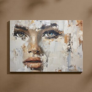 Può includere: Dipinto astratto di un viso di donna con uno schema di colori bianco, grigio e marrone. Gli occhi della donna sono di un blu sorprendente.