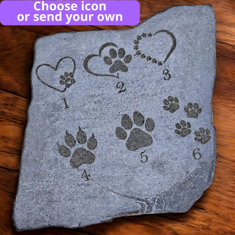 May include: A gray stone with engraved paw prints and heart designs. The text "Choose icon or send your own" is at the top. The stone features six different paw print designs, numbered 1 through 6.