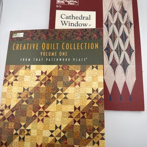 May include: Two instructional quilting books. The front book is titled Creative Quilt Collection Volume One From That Patchwork Place and features a yellow, brown, and red star-patterned quilt. The back book is titled Cathedral Window.
