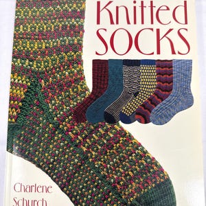 May include: A book cover titled "Sensational Knitted SOCKS" features a close-up of a colorful knitted sock in green, yellow, and red. Several other knitted sock designs are displayed. The author's name, Charlene Schurch, is also visible.