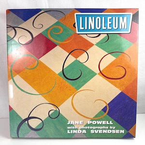 May include: A square book cover titled LINOLEUM by Jane Powell with photographs by Linda Svendsen. The cover features a colorful diamond pattern in shades of blue, green, red, orange, and yellow, overlaid with thin, black, swirling line art.