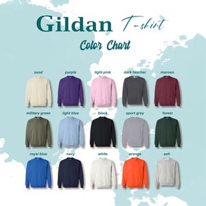 May include: Color chart for Gildan T-shirts showing 15 different colors: sand, purple, light pink, dark heather, maroon, military green, light blue, black, sport grey, forest, royal blue, navy, white, orange, and ash.