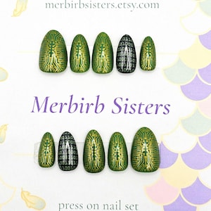 May include: A set of press-on nails with a green and gold circuit board design. One nail features a black background with white binary code. The text "Merbirb Sisters" and "press on nail set" are visible.