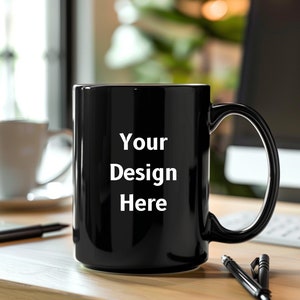 May include: A black ceramic mug with a white inscription that reads "Your Design Here".