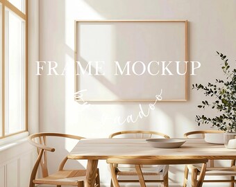 May include: A wooden frame mockup hanging on a white wall in a dining room setting. The frame is empty and ready for your design. The room features a wooden table with chairs and a potted plant.