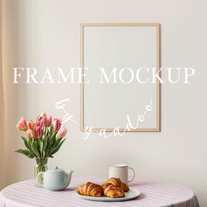May include: A light wooden frame mockup with the text "FRAME MOCKUP" and a handwritten script. A table is set with a vase of pink tulips, a teapot, a mug, and a plate of croissants. The table has a pink and white striped tablecloth.